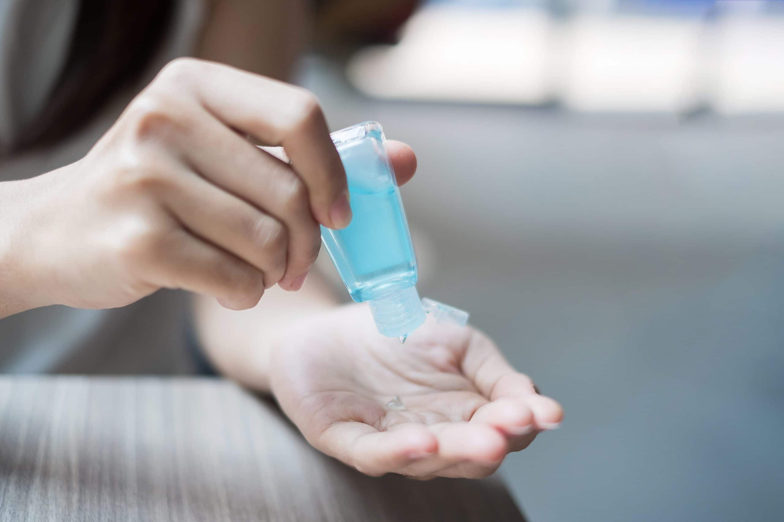 Woman hands using hand sanitiser
